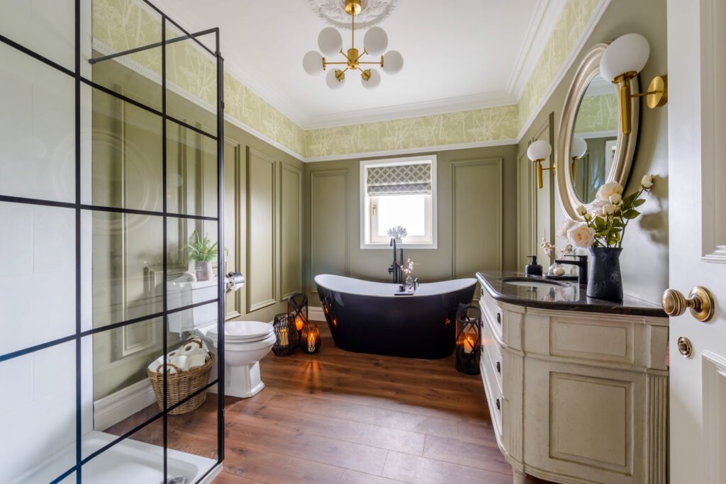 Bathroom featuring freestanding tub, large mirrors and paneled olive walls – Cloyne Farmhouse Part Two project, designed by AK Interior, Cork, Ireland.
