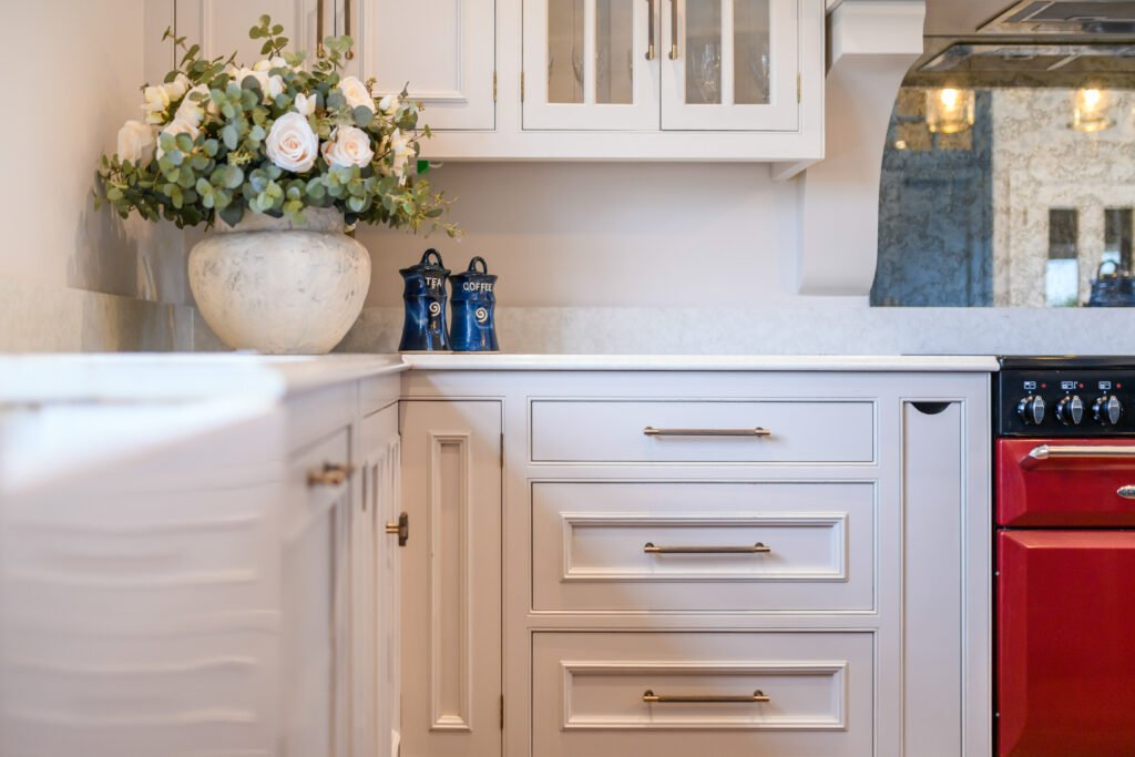 Kitchen counter with white cabinetry and fresh floral décor – Cloyne Farmhouse Part One project, designed by AK Interior, Cork, Ireland.