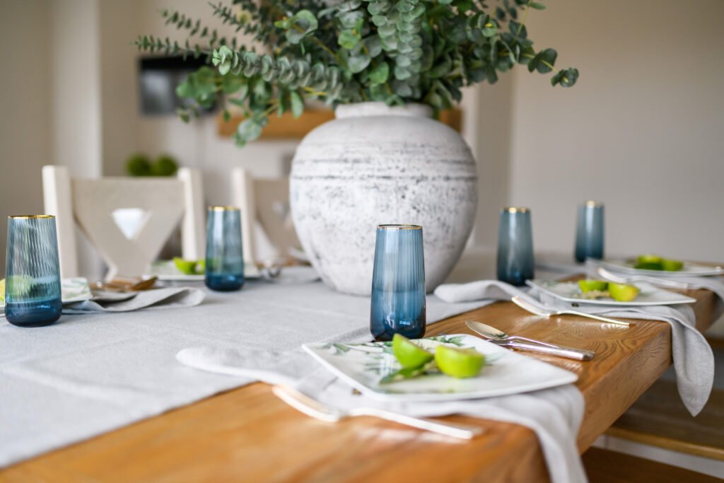 Table setting with textured runner, blue glassware and green accents – Residential project “Cloyne Farmhouse Part One”, designed by AK Interior, Cork, Ireland.