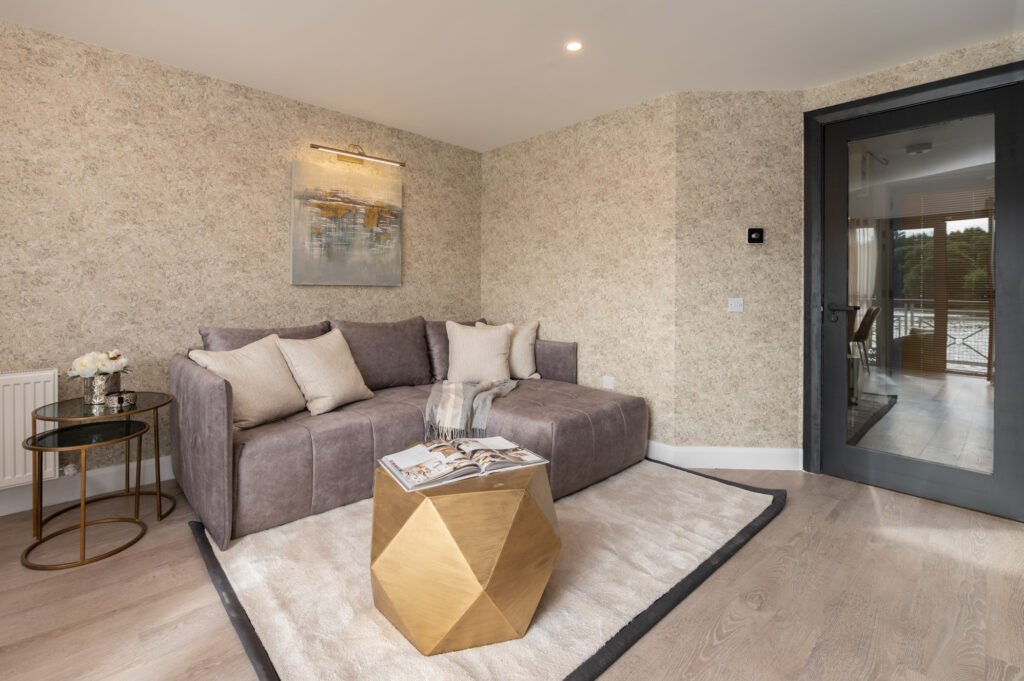 Ceiling pendant light above a grey sofa and textured wall art. West Cork Waterfront project by AK Interior, Cork, Ireland.