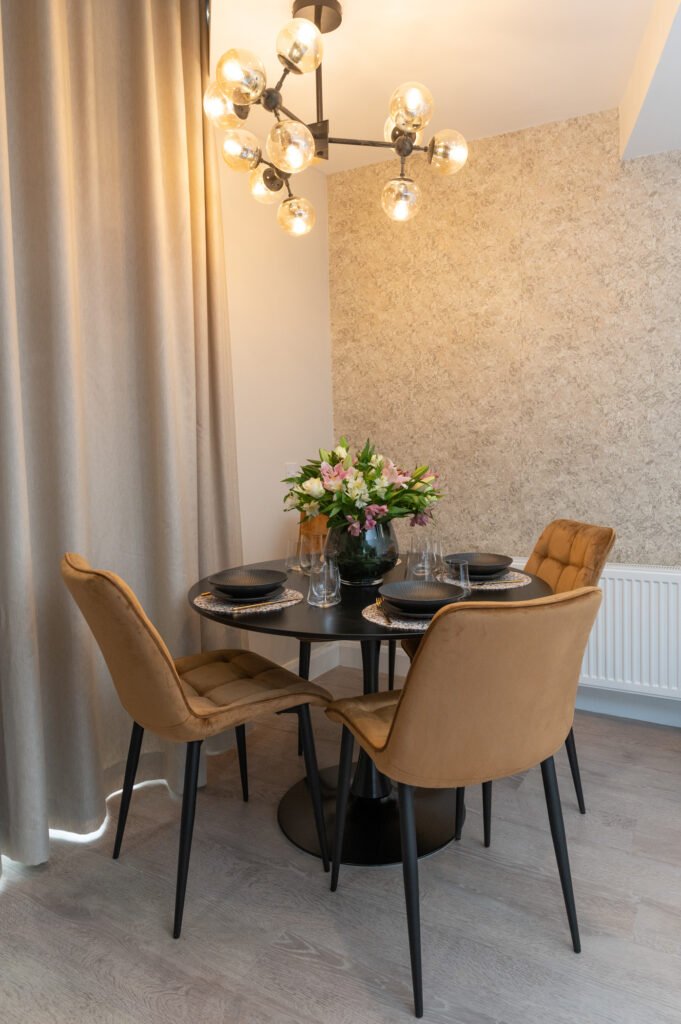 Dining corner with a flower vase and modern ceiling light. West Cork Waterfront project by AK Interior, Cork, Ireland.