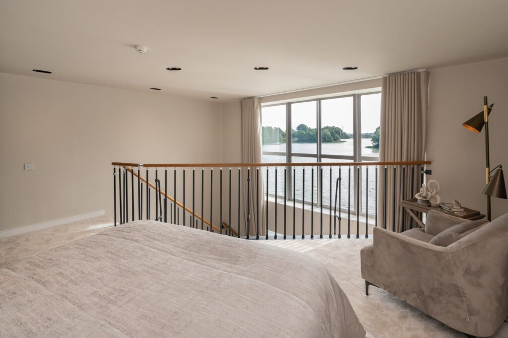 Bedroom with bed and railing near the window. West Cork Waterfront project by AK Interior, Cork, Ireland.