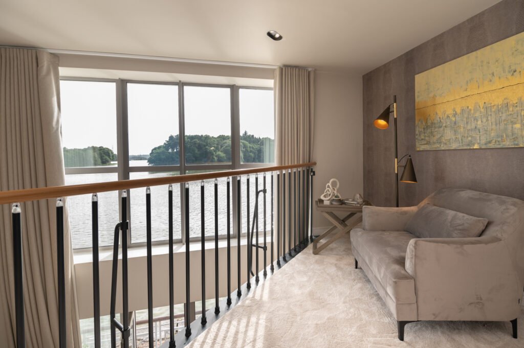 Bright bedroom with white bedding and river-facing balcony – Wharf Penthouse, residential project by AK Interior, Cork, Ireland.