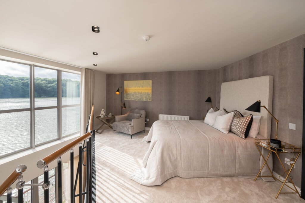 Warm-toned bedroom with cushioned headboard and abstract artwork – Wharf Penthouse, residential project by AK Interior, Cork, Ireland.