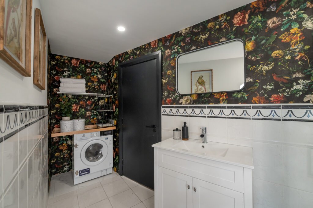 Bathroom with dark floral wallpaper and white vanity unit – Wharf Penthouse, residential project by AK Interior, Cork, Ireland.