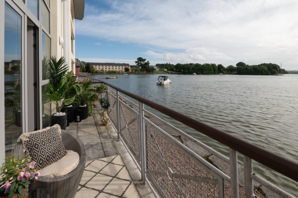 Balcony with outdoor seating overlooking waterfront – Wharf Penthouse, residential project by AK Interior, Cork, Ireland.