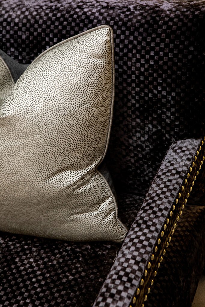 Decorative cushion on a dark textured armchair with gold studs – Blarney Residential, AK Interior, Cork