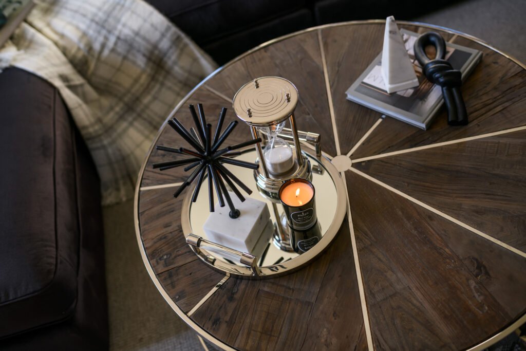 Styled round wooden coffee table with candle, books and decorative objects, Rathmore Residential project, AK Interior, Cork.