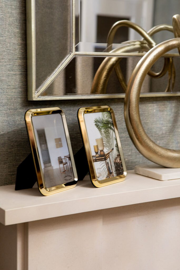 Gold photo frames and sculpture displayed on the fireplace – Blarney Residential, AK Interior, Cork
