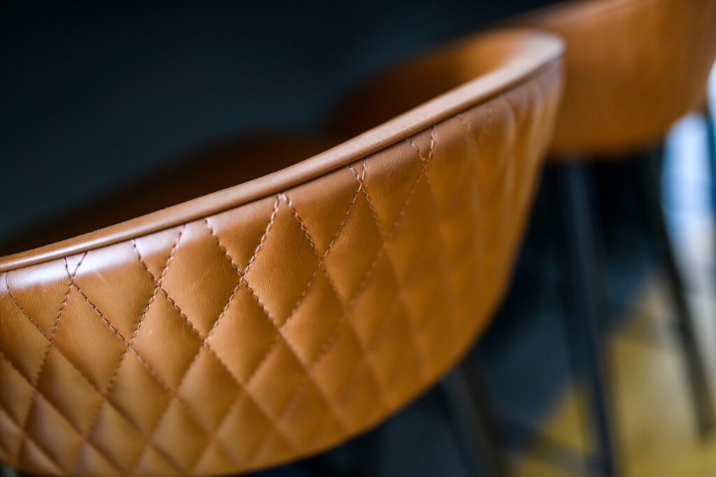 Close-up of a brown leather dining chair – Whitegate Holiday Home, AK Interior, Cork