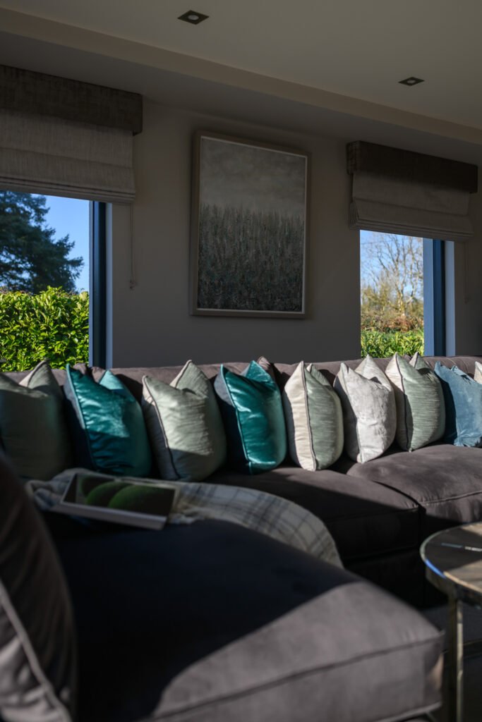 Window wall with roman blinds, framed landscape artwork and views to the garden, Rathmore Residential project, AK Interior, Cork.