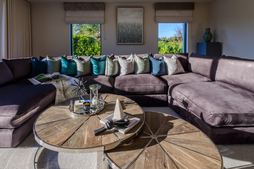 Sofa corner with layered teal and grey cushions under textured landscape painting, Rathmore Residential project, AK Interior, Cork.