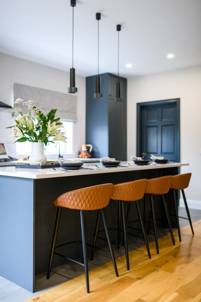 Kitchen island with brown bar stools and black pendant lights – Whitegate Holiday Home, AK Interior, Cork