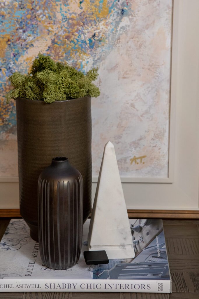 Dark vase with flowers and tall candle holders on a wooden table – Blarney Residential, AK Interior, Cork