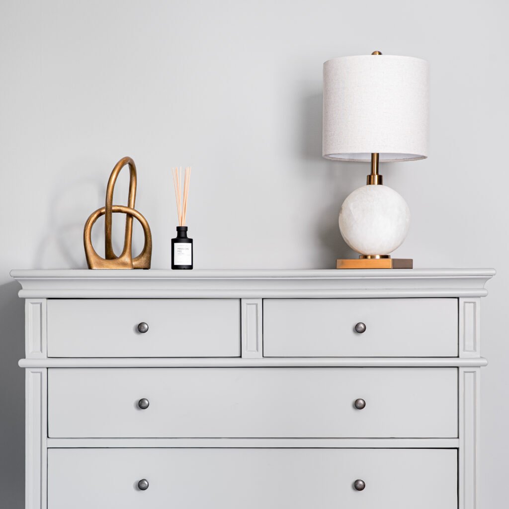 Soft grey chest of drawers with round lamp and reed diffuser – Douglas Part One project, designed by AK Interior, Cork, Ireland.