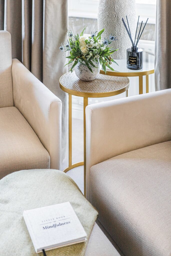 Armchair corner with fresh floral arrangement, reed diffuser and textured lamp – Douglas Part One project, designed by AK Interior, Cork, Ireland.