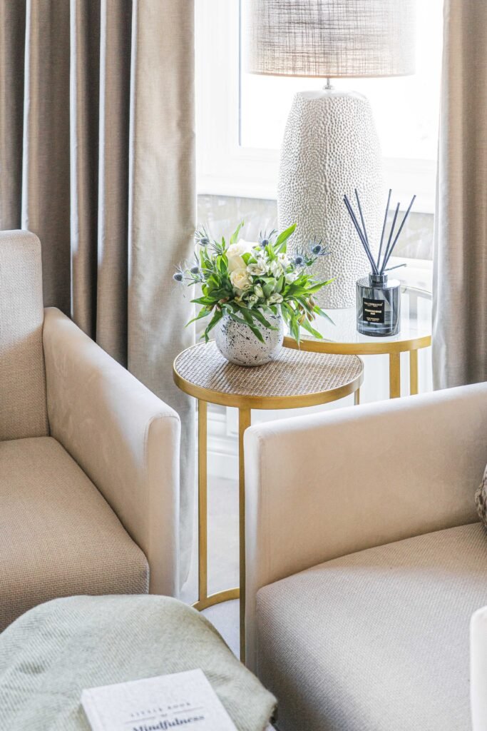 Beige armchair with textured throw and tall elegant curtains – Douglas Part One project, designed by AK Interior, Cork, Ireland.