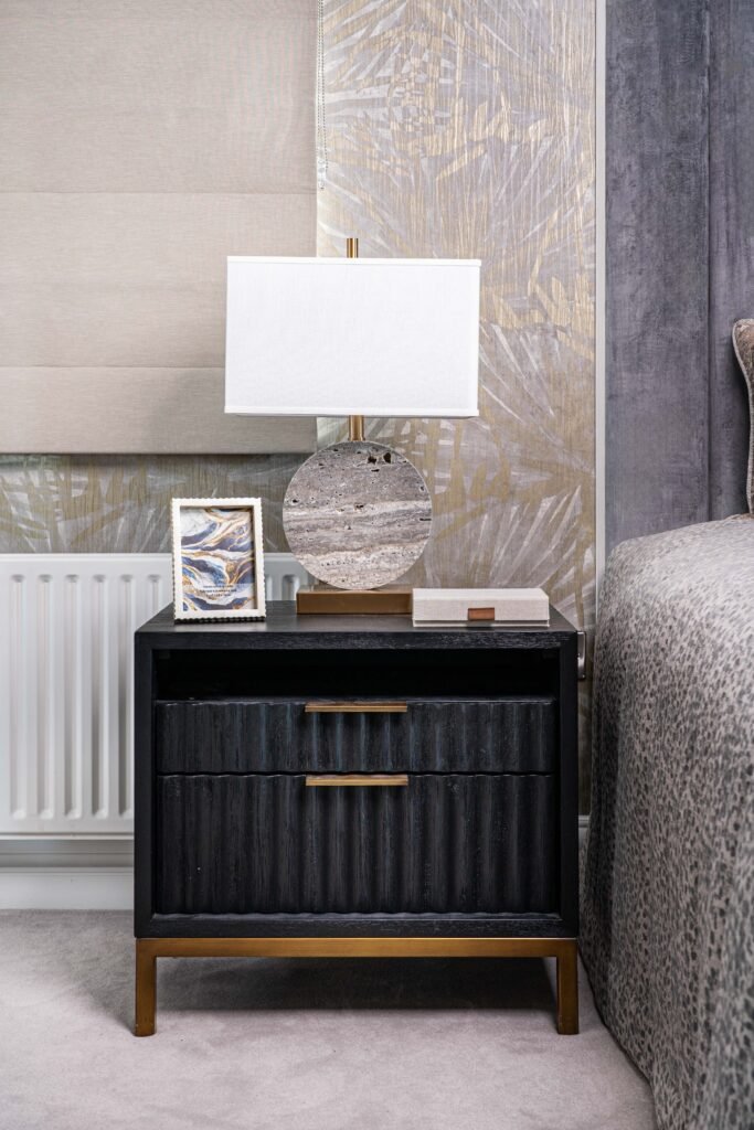 Black bedside table with sculptural lamp and framed decor – Douglas Part One project, designed by AK Interior, Cork, Ireland.