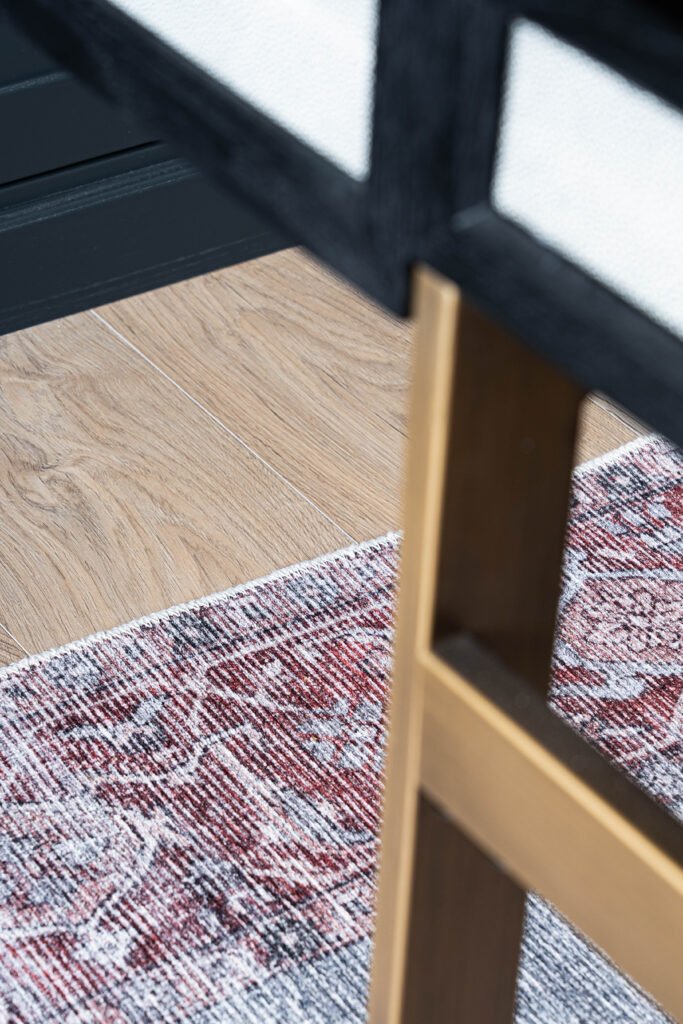Close-up of rug texture and desk leg detail – Douglas Part Two, AK Interior, Cork