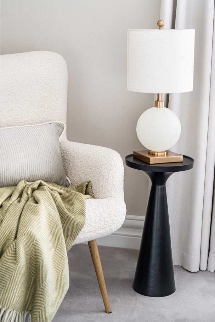 Seating area with a white chair, green throw and decorative table lamp – Douglas Part Two, AK Interior, Cork