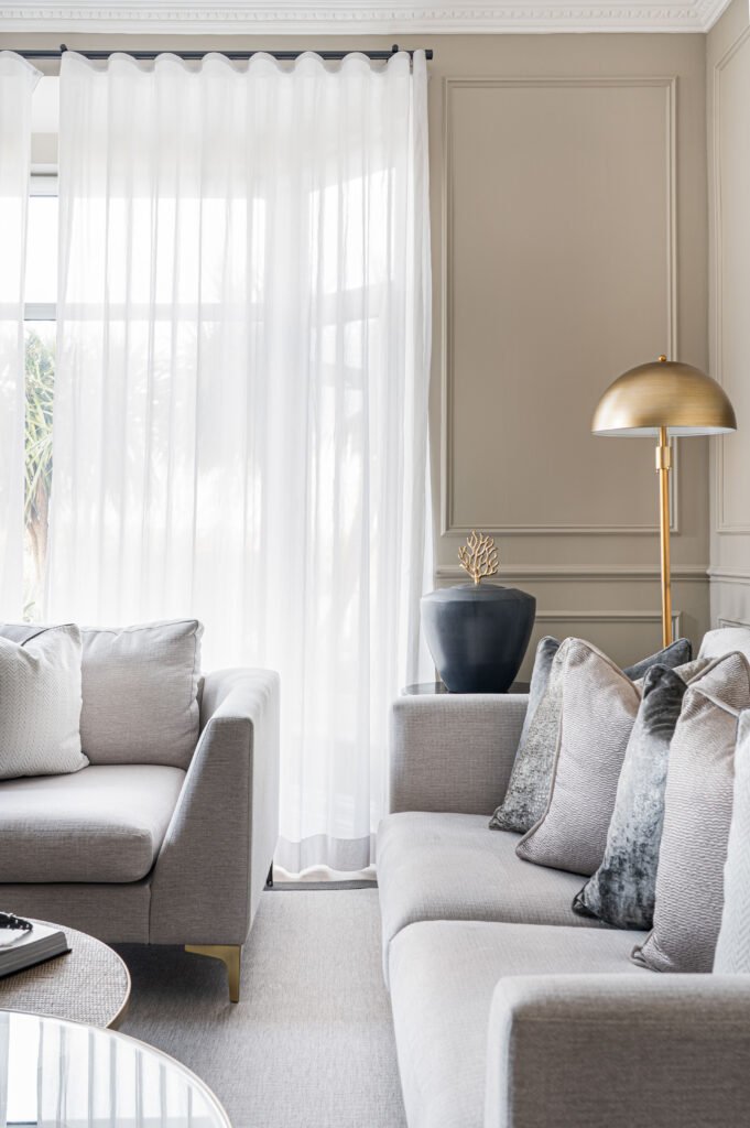 Bright living room corner with grey sofas and a gold floor lamp – Douglas Part Two, AK Interior, Cork