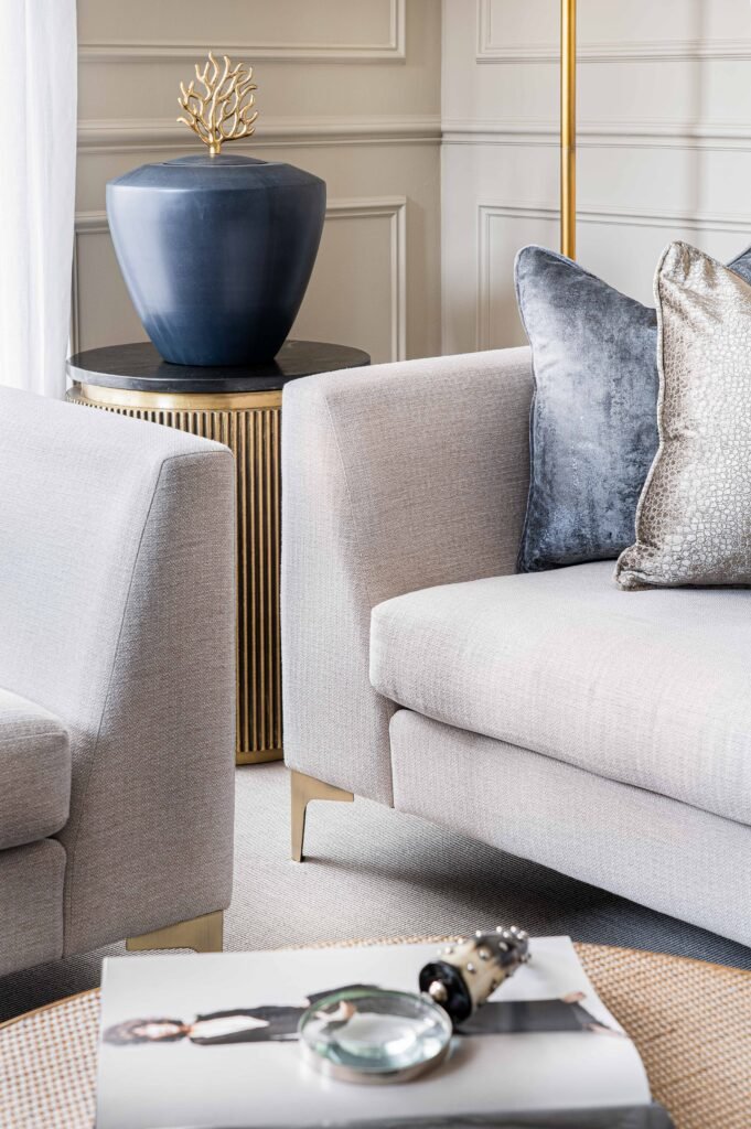 Grey sofa with decorative cushions and a blue ceramic pot on a side table – Douglas Part Two, AK Interior, Cork