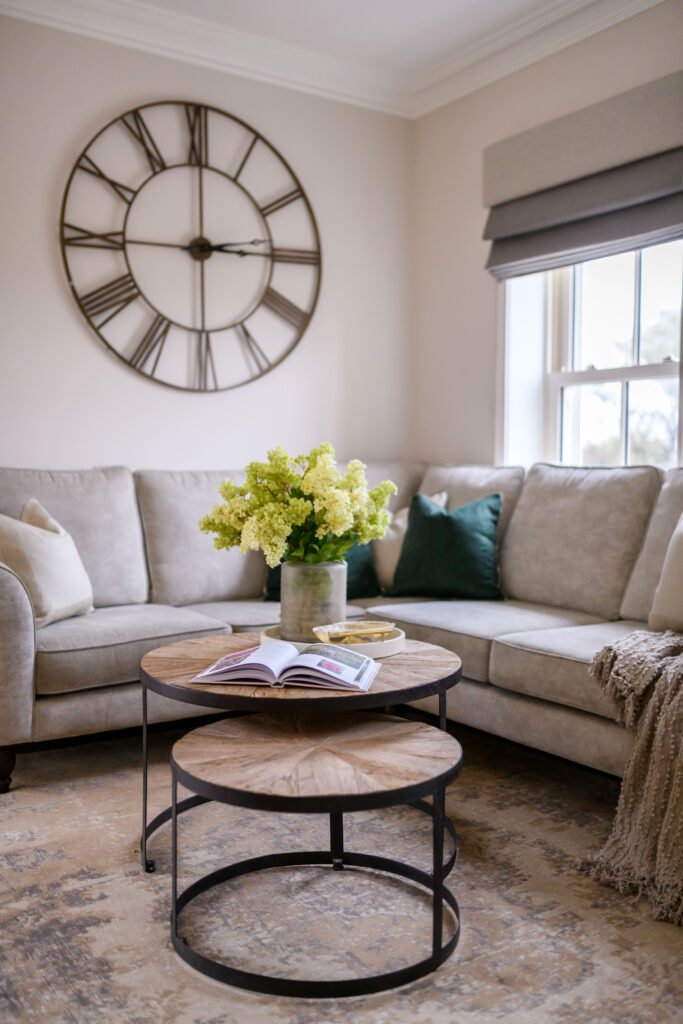 Statement wall clock above L-shaped sofa with textured cushions – Residential project “Cloyne Farmhouse Part One”, designed by AK Interior, Cork, Ireland.