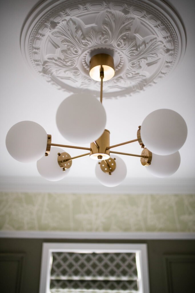 Ornate ceiling rose with contemporary brass and globe chandelier – Cloyne Farmhouse Part Two project, designed by AK Interior, Cork, Ireland.