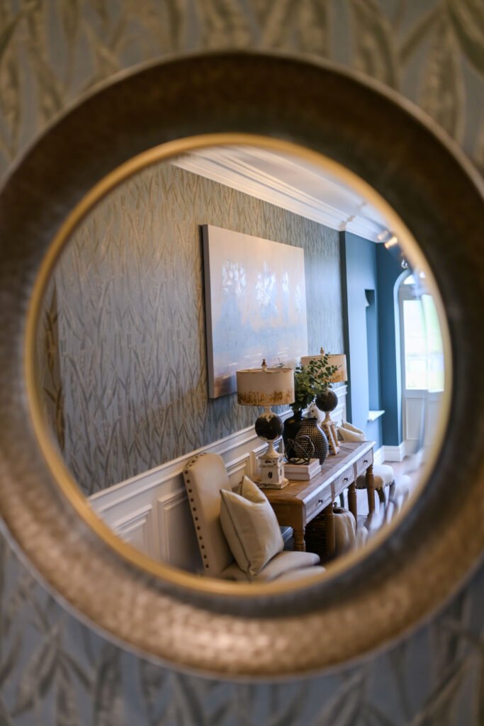 Round decorative mirror reflecting styled console and wallpaper – Cloyne Farmhouse Part Two project, designed by AK Interior, Cork, Ireland.