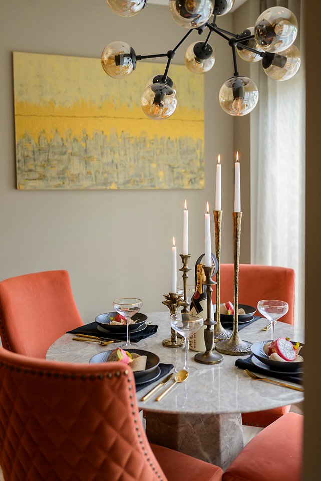 Dining area with orange chairs, round marble table, and large artwork. City Townhouse Residential project, AK Interior, Cork.