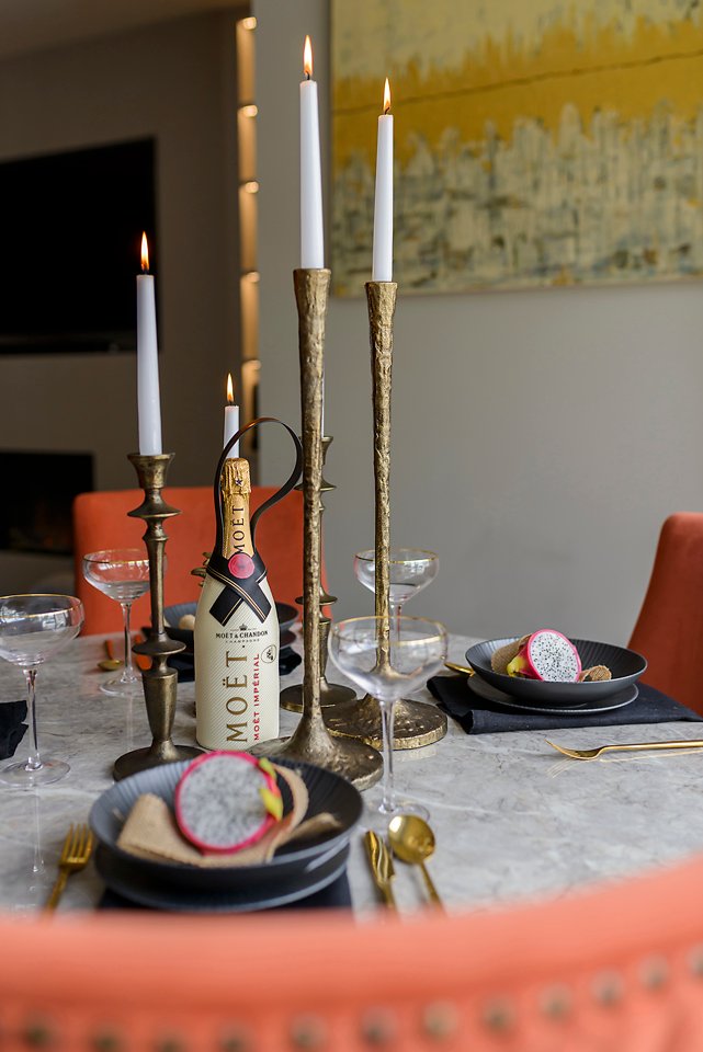 Styled dining table with fruit plates, wine bottles, and modern tableware. City Townhouse Residential project, AK Interior, Cork.