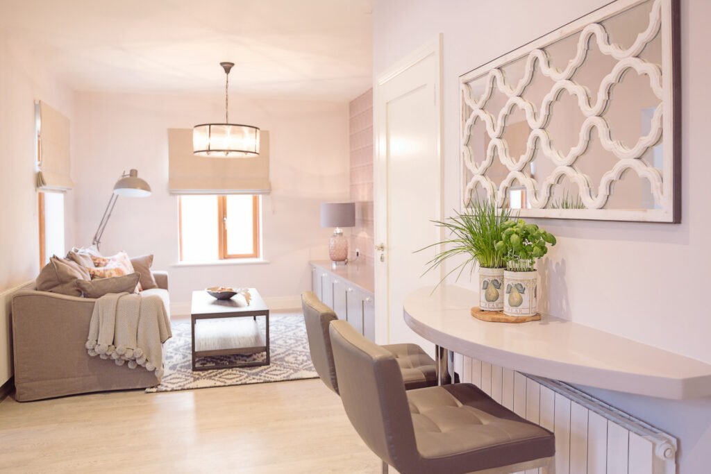 Living room with sofa, coffee table, decorative mirror and console – Innishannon Showhouse by AK Interior, Cork Ireland.
