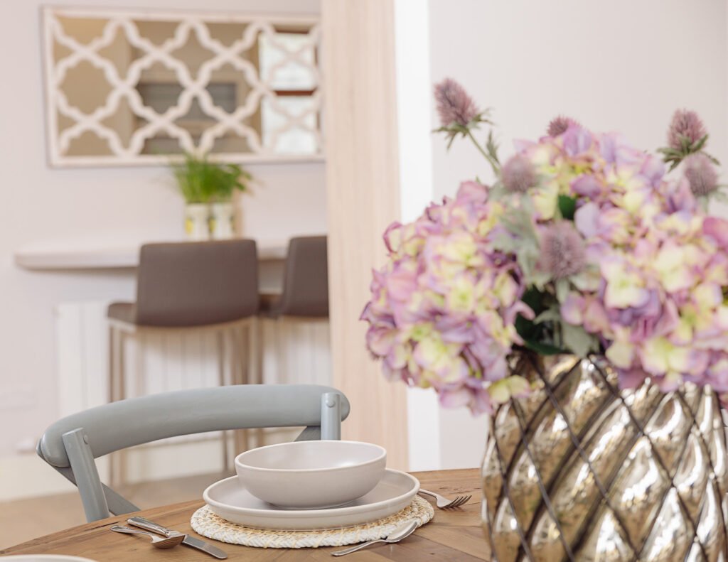 “Close-up of dining chairs around wooden table near stove – Innishannon Showhouse by AK Interior, Cork Ireland.