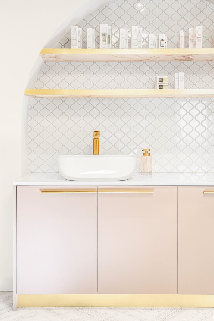 Arched vanity niche with a white basin, gold tap and tiled backdrop – Bon Me project, designed by AK Interior Cork.