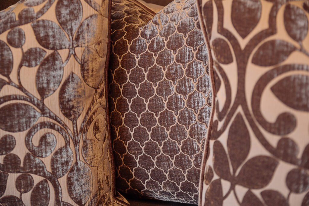 Close-up of decorative patterned cushions in warm earthy tones – Innishannon Showhouse by AK Interior, Cork Ireland.