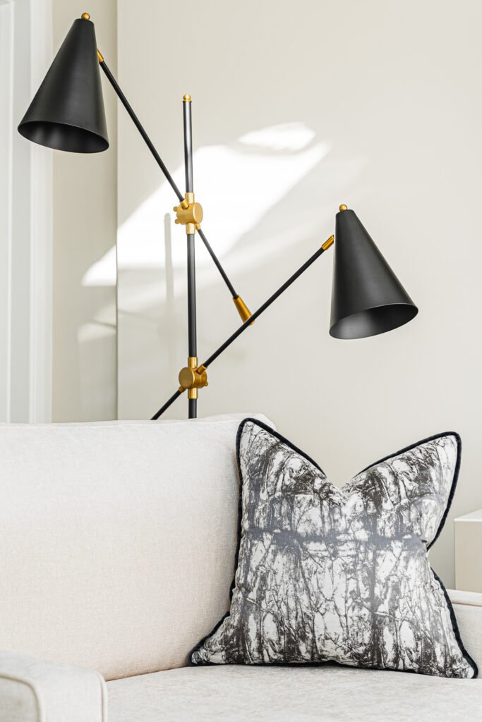 Black floor lamp next to a light sofa – Moneygurney Road Part One, AK Interior