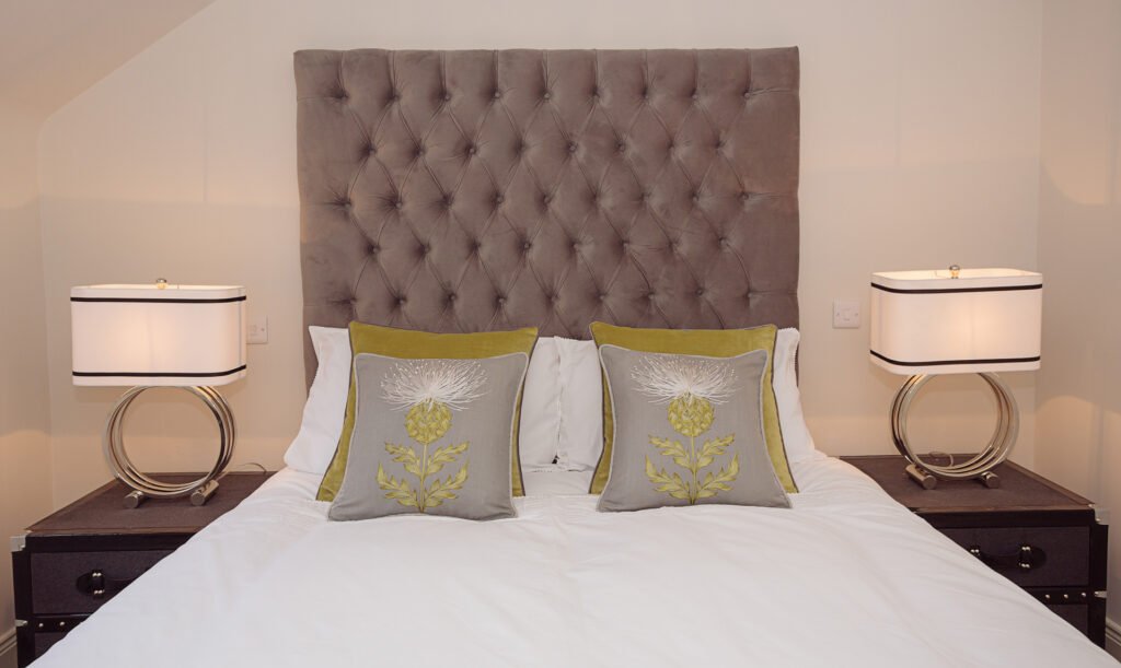 Bedroom detail with tufted headboard, matching bedside tables and accent cushions – Innishannon Showhouse by AK Interior, Cork Ireland.
