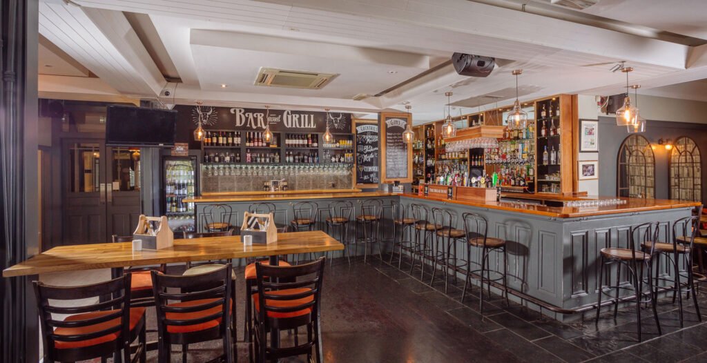 Open restaurant view with central bar, high stools and mix of tables and banquette seating. Briar Rose Commercial project, AK Interior, Cork.