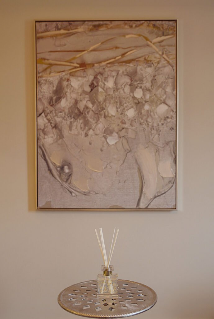 Abstract wall art with neutral tones and reed diffuser on perforated metal side table – Innishannon Showhouse by AK Interior, Cork Ireland.