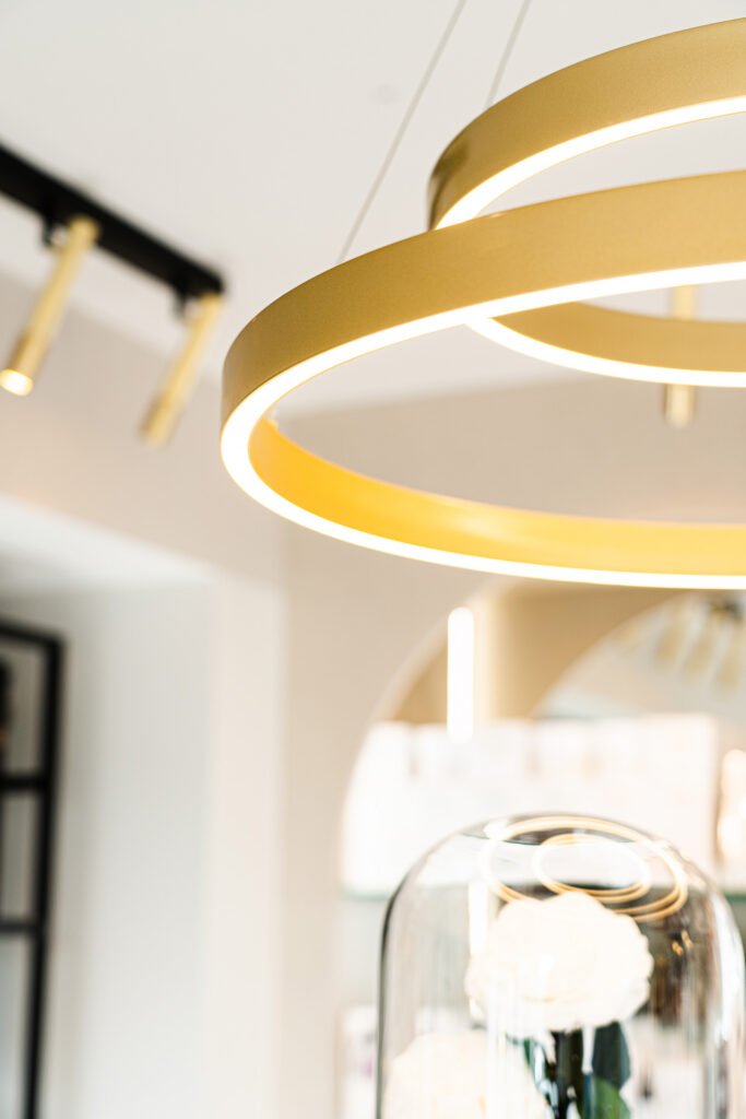 Gold circular ceiling light in a modern soft-toned interior – Bon Me project, designed by AK Interior Cork.