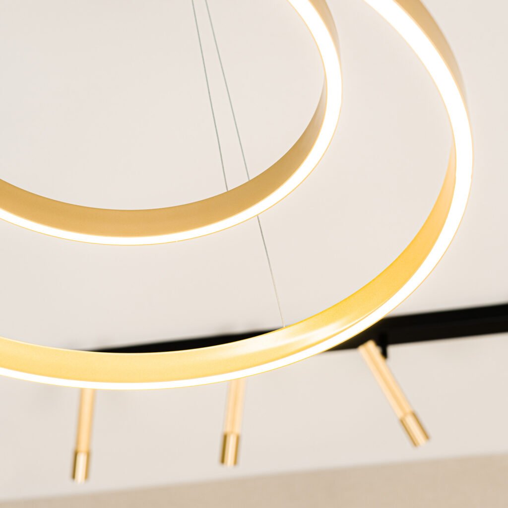 Gold ring ceiling light paired with modern linear spotlights – Bon Me project, designed by AK Interior Cork.