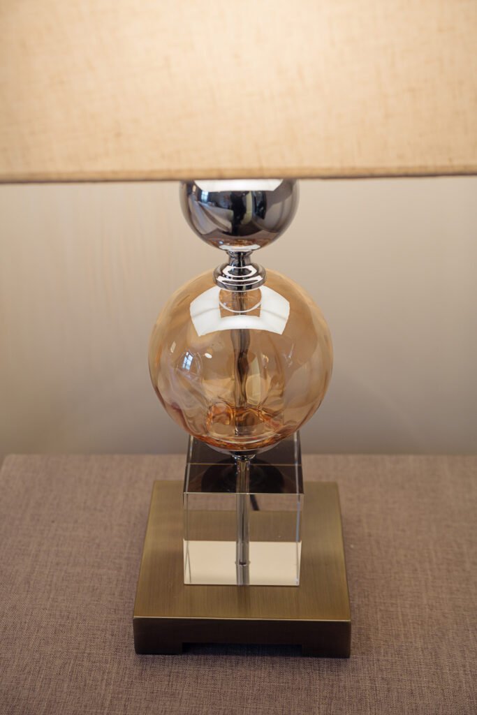 Amber glass sphere table lamp with chrome and acrylic base – Innishannon Showhouse by AK Interior, Cork Ireland.