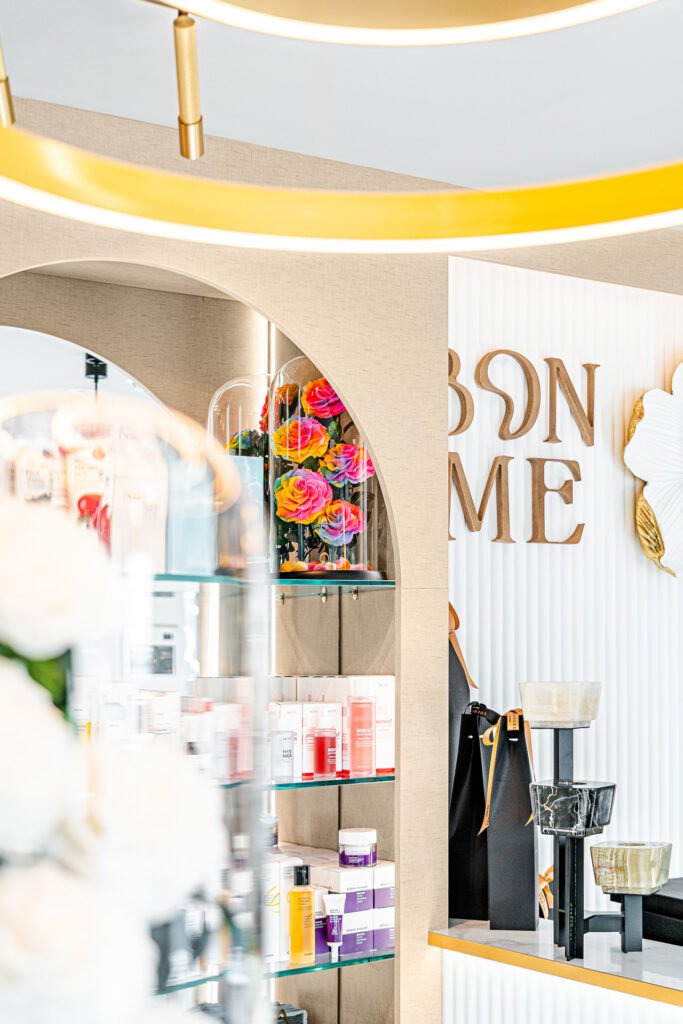 Glass shelves under arched niche showcasing preserved roses and premium skincare products – Bon Me project, designed by AK Interior Cork.