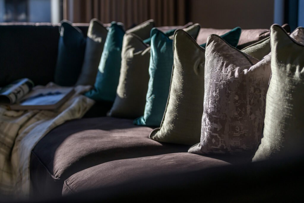 Sunset light on deep sofa with teal cushions and soft throw, Rathmore Residential project, AK Interior, Cork.