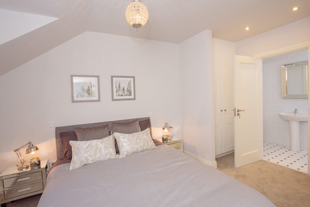 Calm grey bedroom with framed wall art and ensuite bathroom entrance – Innishannon Showhouse by AK Interior, Cork Ireland.