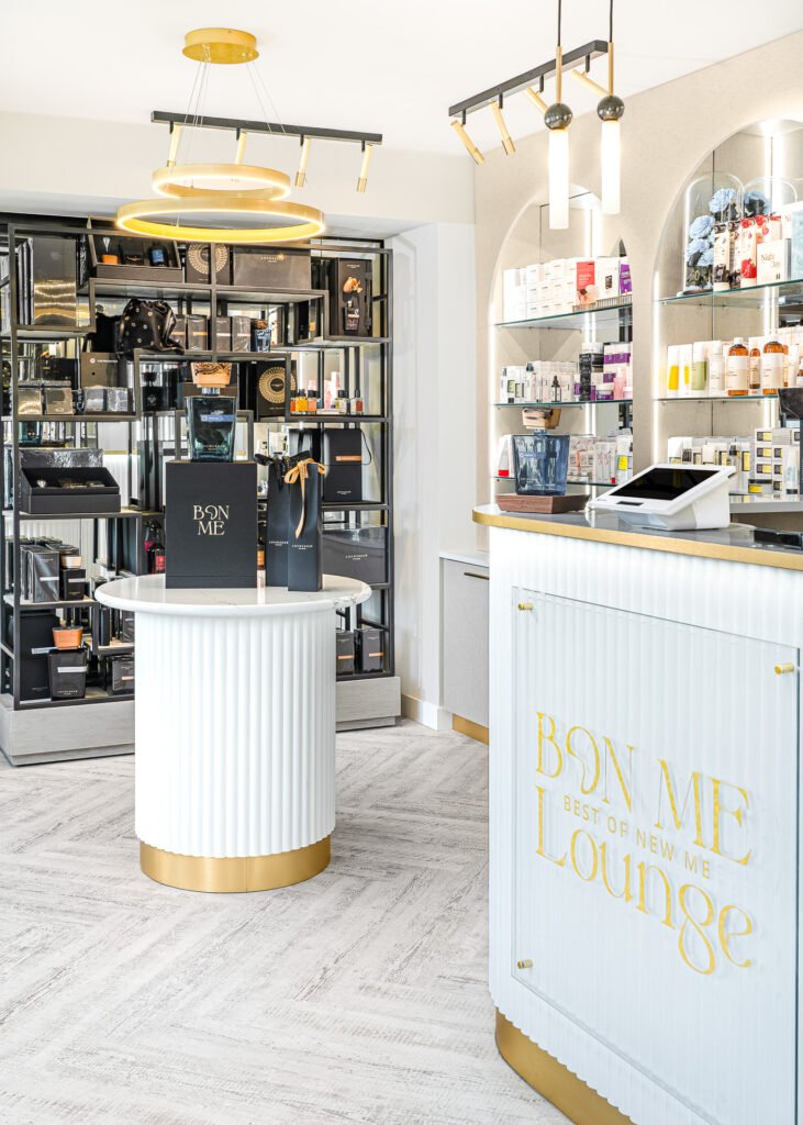 BON ME Lounge reception desk with gold accents and illuminated product displays – Bon Me project, designed by AK Interior Cork.