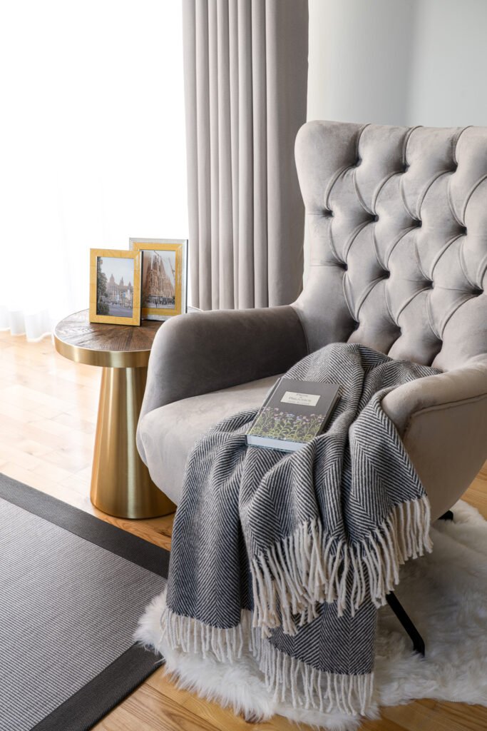 Soft armchair with blankets by the window – Moneygurney Road Part One, AK Interior