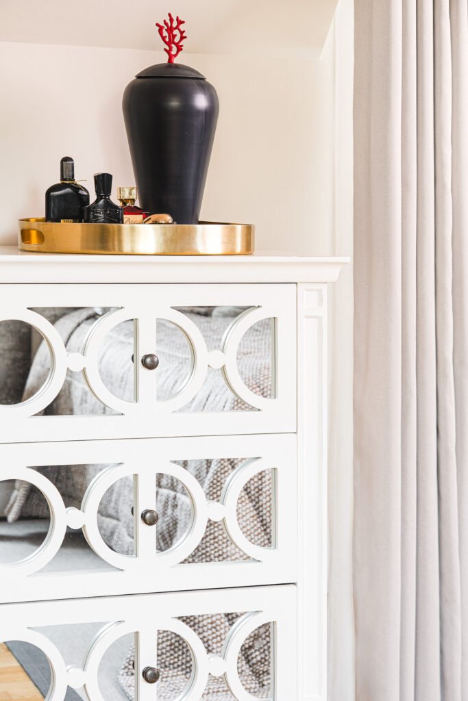 Luxurious bedroom detail featuring a velvet grey armchair, a gold side table, and soft neutral curtains – Moneygurney Road Part One, AK Interior