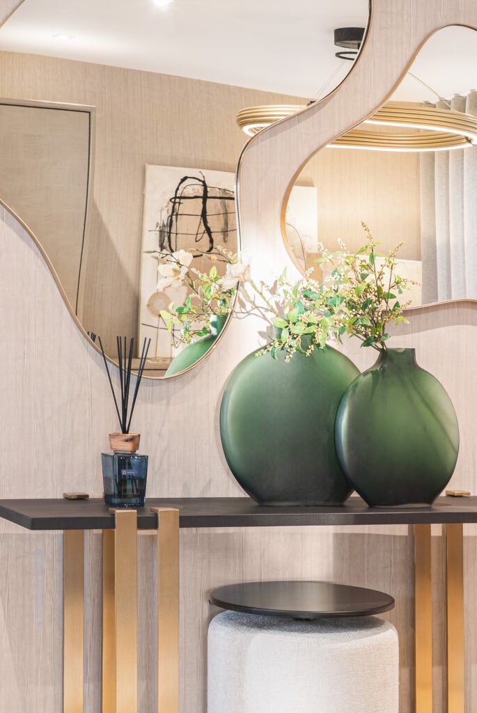 Decorative metal table with black vases and greenery – Luxury Living Room Part Two by AK Interior.