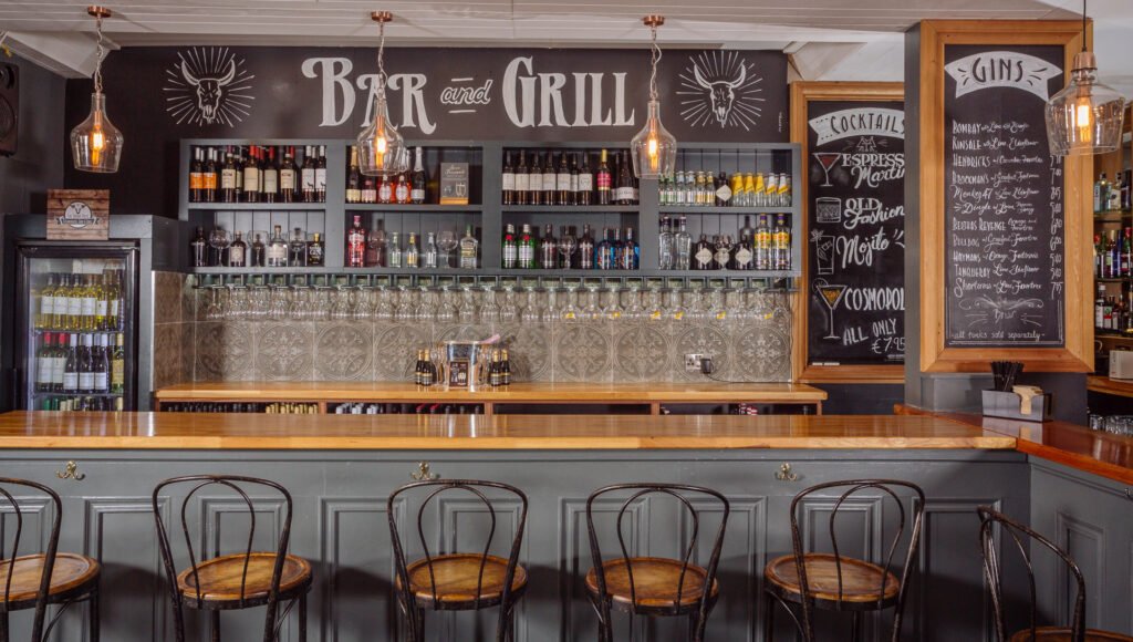 Feature bar with chalkboard menu, hanging glasses and rustic timber details. Briar Rose Commercial project, AK Interior, Cork.
